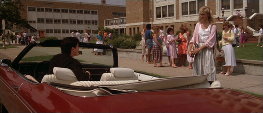 What Does Lynchian Mean? His Surreal Style in Film Explained 2 A young man in a red convertible looks at a girl standing outside a high school in Blue Velvet (1986)