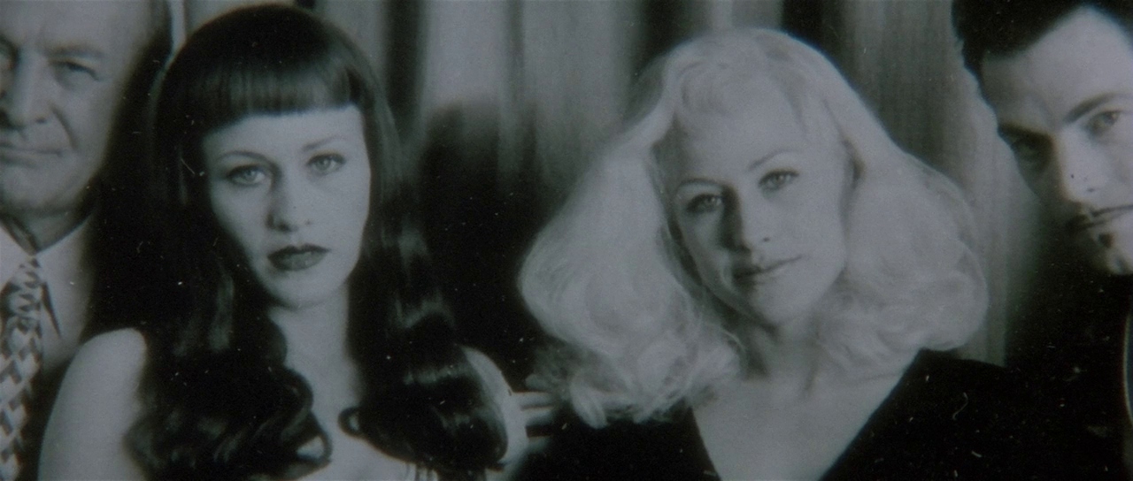 What Does Lynchian Mean? His Surreal Style in Film Explained 3 A strange photo shows two women with different hair colors and styles standing together in Lost Highway (1997)