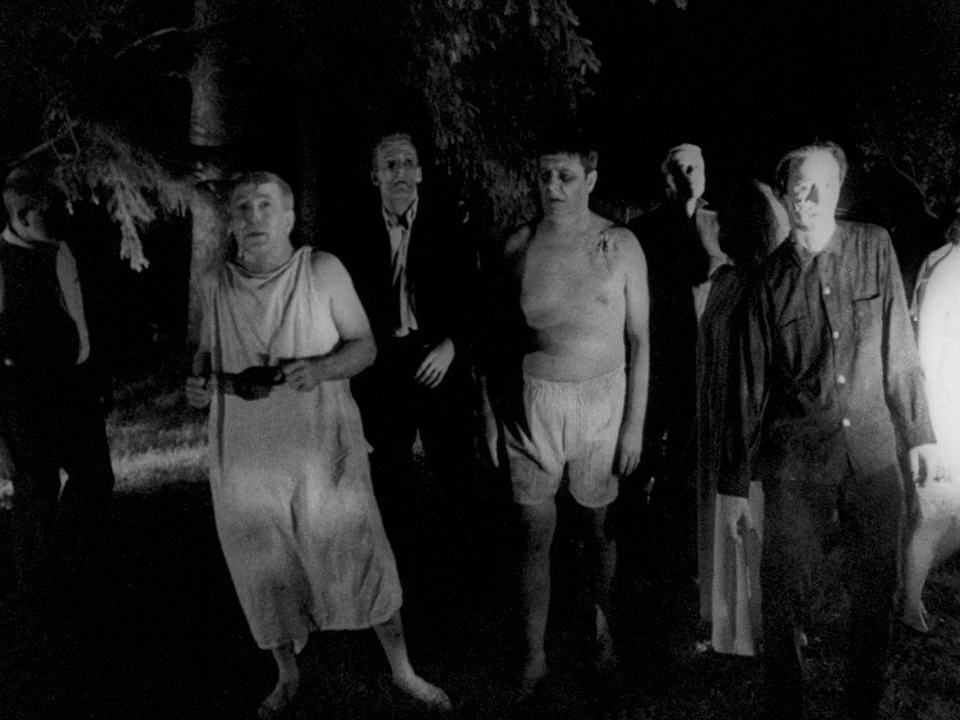 What Is a B-Movie? Definition & Film History 5 Black-and-white shot of zombies approaching at night, lit from the front with shadows behind them.