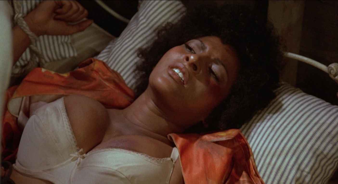 What Is a Grindhouse Movie? Definition & Origins 2 Pam Grier in bed, bruised but alert, from the film Foxy Brown (1974)