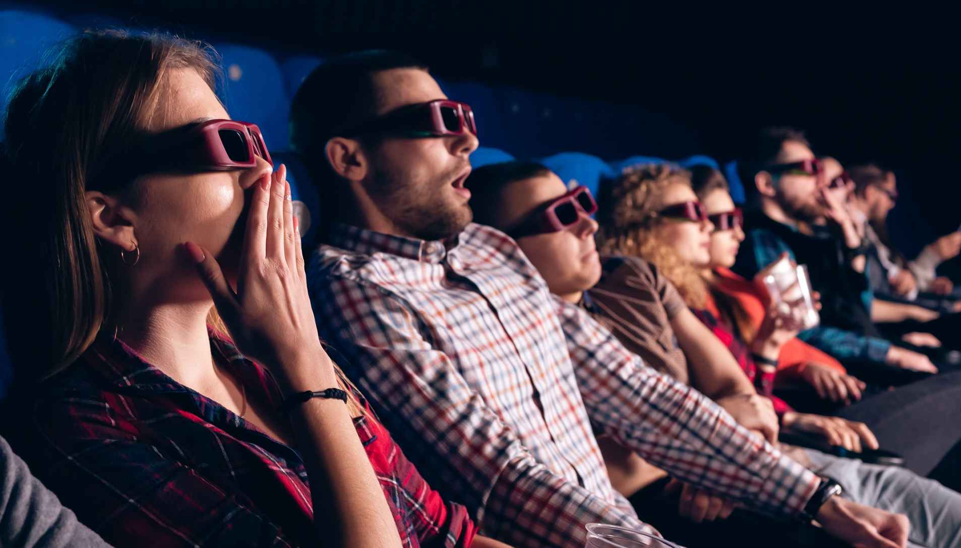 What Is a 3D Movie? Definition, History & Examples 4 Moviegoers reacting while watching a film in polarized 3D glasses