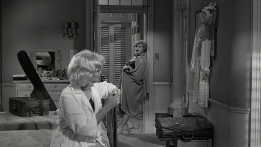 What is a Romcom? Definition, History & Tropes 12 Marilyn Monroe in a hotel room with another woman in doorway, from Some Like It Hot (1959)