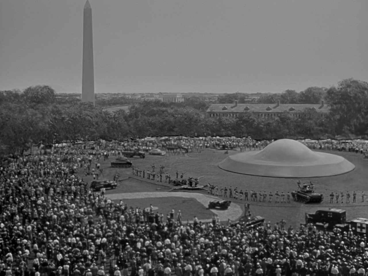 What Is Science Fiction? Definition & Film Origins Explained 4 A flying saucer has landed on a Washington D.C. lawn as a massive crowd and military tanks gather around it in The Day the Earth Stood Still (1951)
