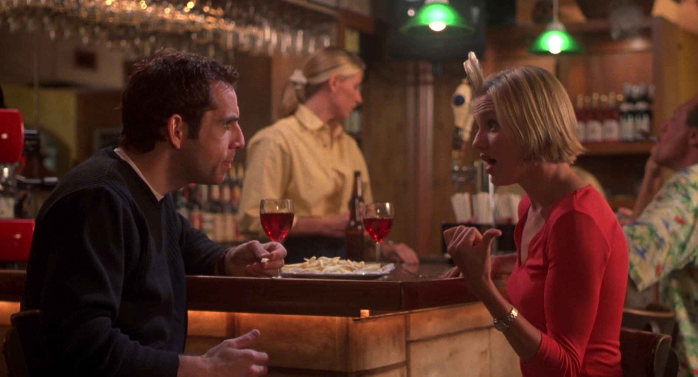 What is a Romcom? Definition, History & Tropes 2 Ben Stiller and Cameron Diaz talk at a bar with wine glasses in front of them