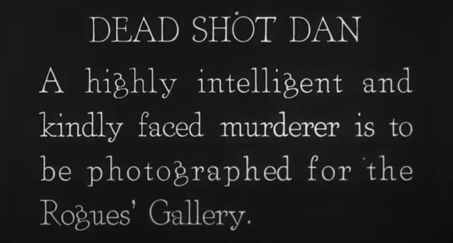 What Is a Silent Movie? Definition & History Explained 4 Silent film title card reading “Dead Shot Dan: A highly intelligent and kindly faced murderer is to be photographed for the Rogues' Gallery.”
