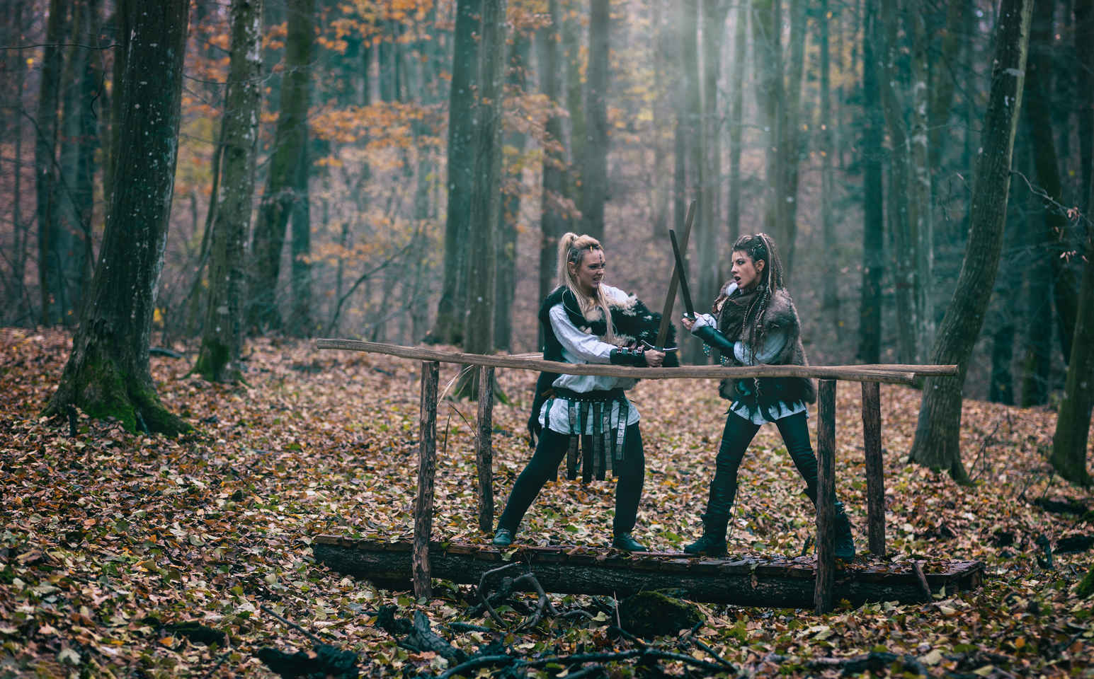 What is a Weapons Master? Job Description, Training & Safety 3 Two actors practicing sword combat on a small wooden bridge with weapons master supervision.