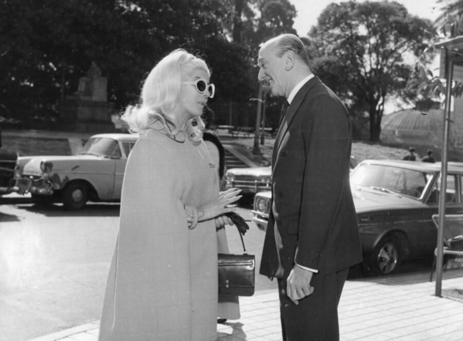 What Are Sexploitation Films? Definition, Movies & Global Impact 11 Libertad Leblanc in sunglasses talks with Héctor Méndez in a street scene from Deliciosamente amoral (1969)