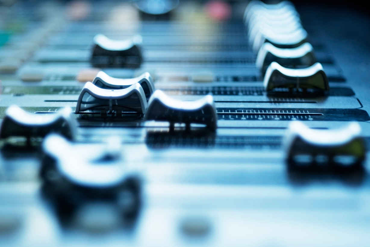 What Does a Sound Designer Do? Job Description, Salary & How to Start 4 Close-up of sound mixing console faders