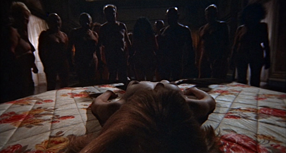 What Is a Proof-of-Concept Film? Meaning, Examples & How They Work 2 Rosemary lies frozen on a bed while shadowy figures surround her in a cult ritual scene from Rosemary’s Baby (1968).