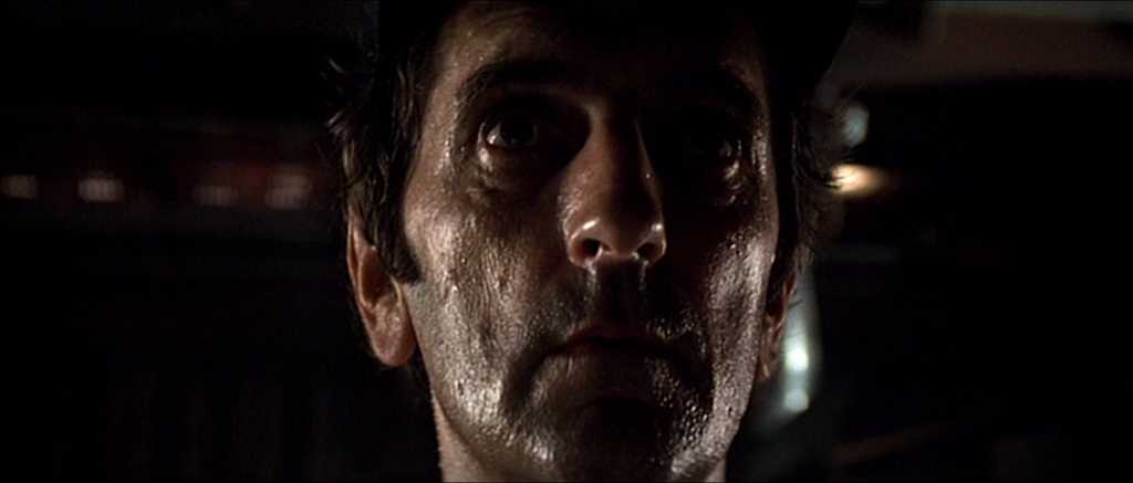What is a Character Actor? Definition, Traits, Roles & Examples 5 Harry Dean Stanton as Brett in Alien (1979), looking up in a dimly lit shot that highlights his sweat-covered face.