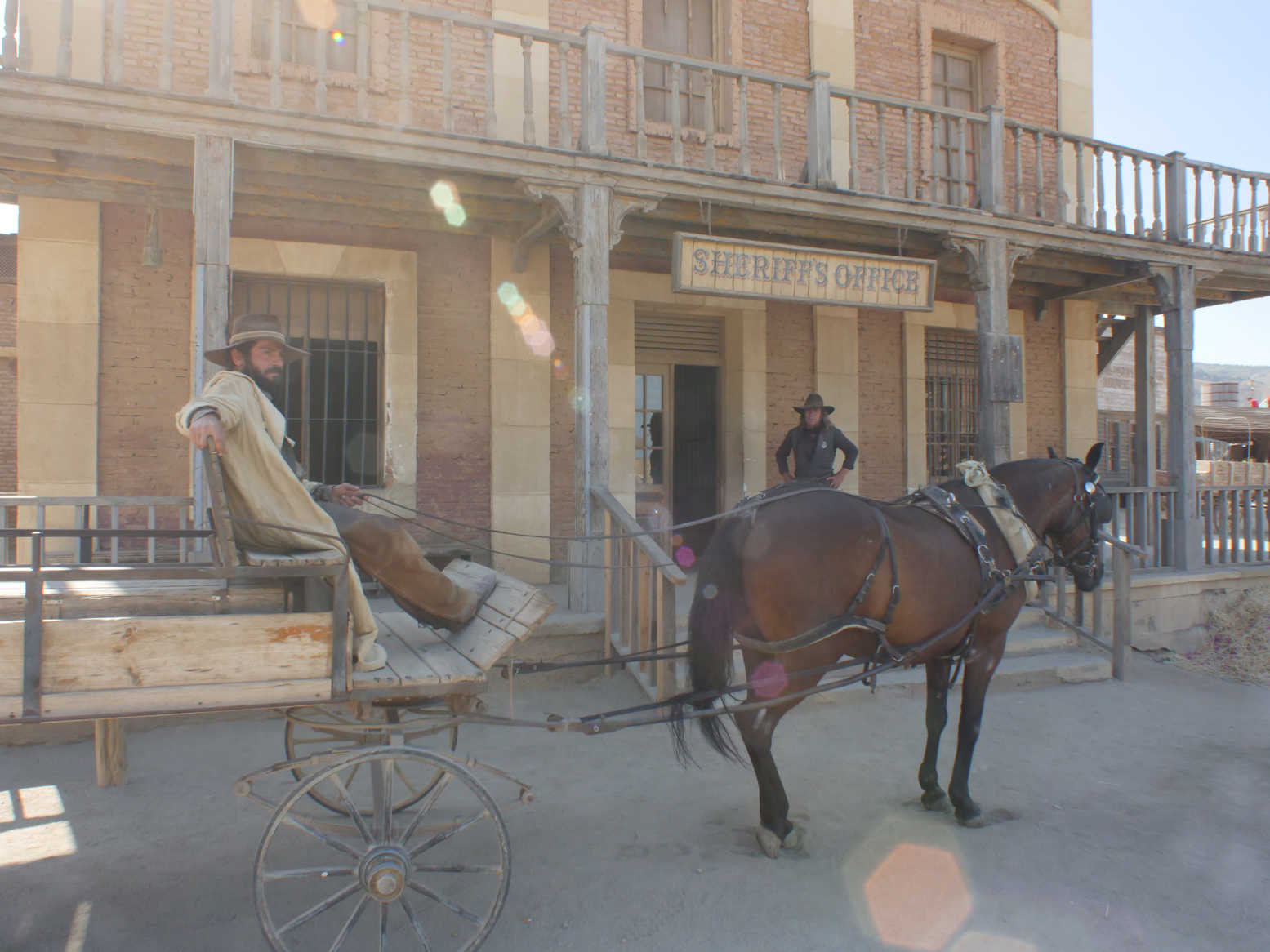 What Is Lens Flare? Types, Causes & Control 4 Old western wagon in front of sheriff’s office with lens flare artifacts shaped like polygons