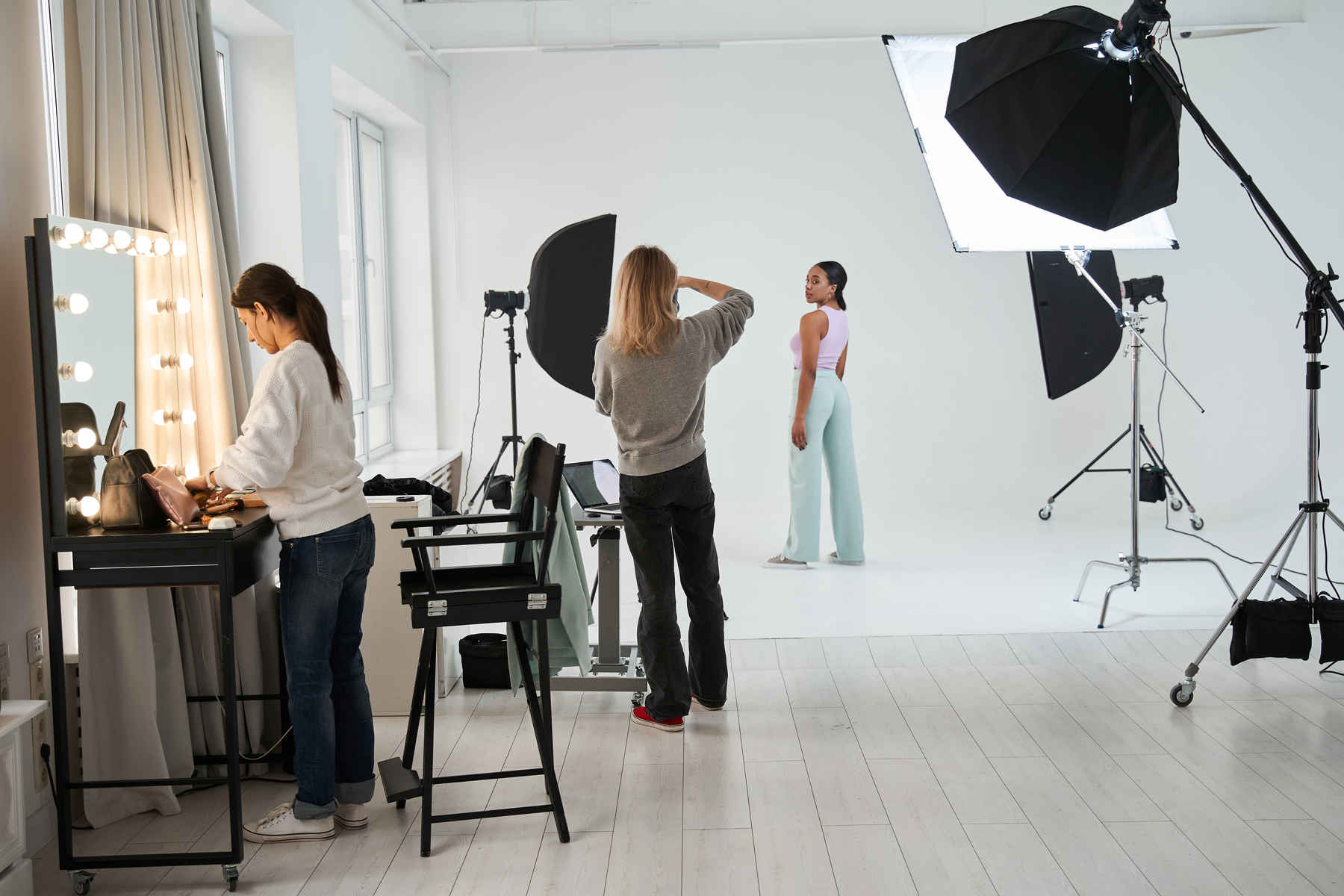 What Is a Light Diffuser for in Photography? Definition & Examples 2 Studio portrait session with two softbox light diffusers directed at a model.