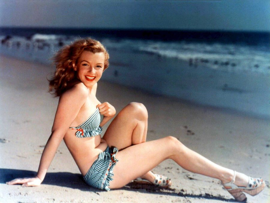 What Is Glamour Photography? Definition & Complete Guide to Style 3 Marilyn Monroe posing in striped bikini on the beach in a 1940s pin-up photo
