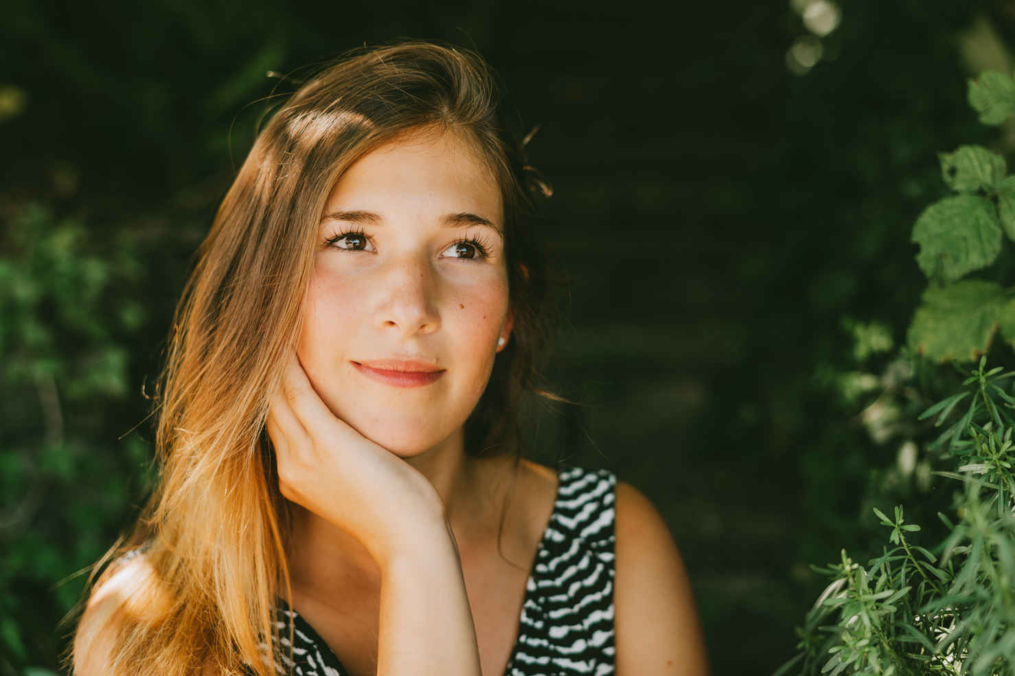 Types of Photography: Genres, Styles & Techniques Explained 41 Young woman in striped dress with natural light falling on her face, softened by shadow