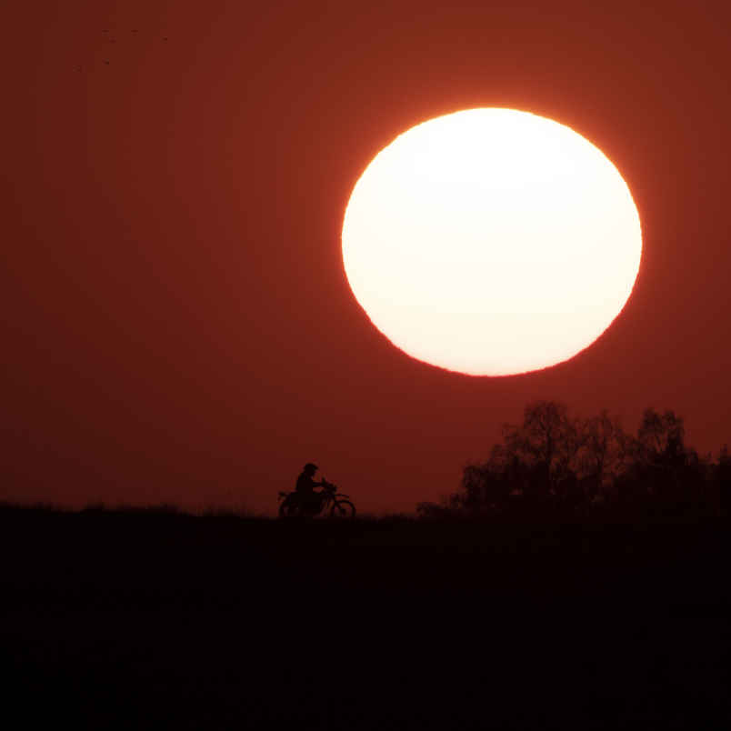 What Is the Exposure Triangle? Aperture, Shutter Speed & ISO Explained 6 Guy on a motor cykel driving on a road at sunset