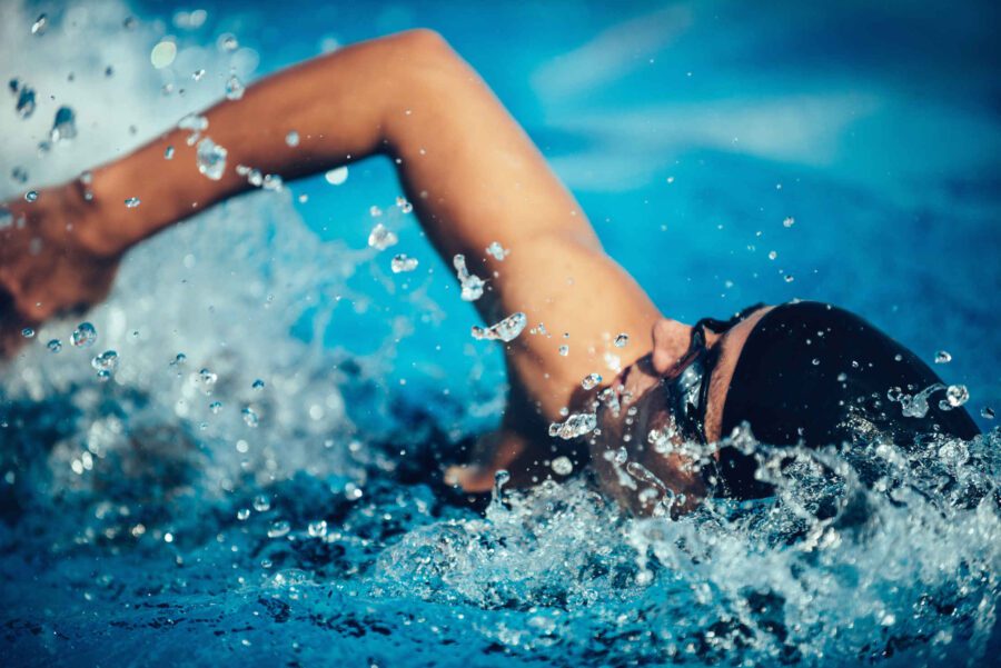 Types of Photography: Genres, Styles & Techniques Explained 15 Close-up of swimmer mid-stroke with water splashing in sharp detail