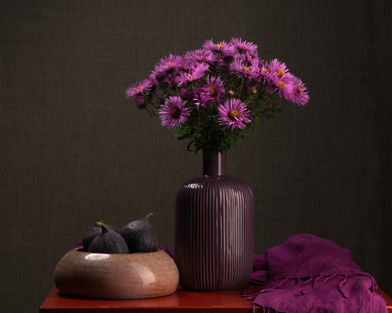 Types of Photography: Genres, Styles & Techniques Explained 27 Still life composition with purple flowers in a vase, figs in a bowl, and draped cloth