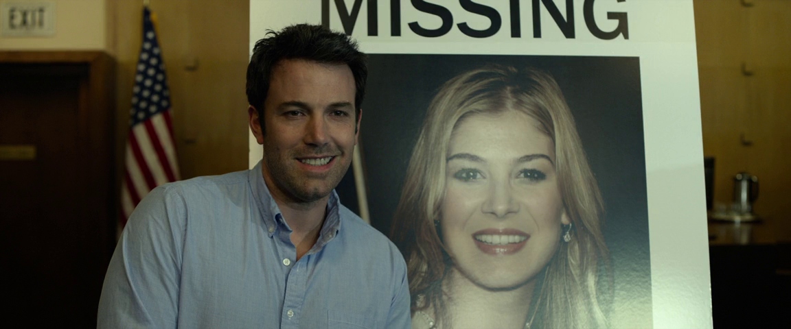 What is the Rashomon Effect? When Stories Conflict in Film 2 Nick Dunne stands next to a large missing-persons poster of his wife, Amy, smiling awkwardly in front of the media.