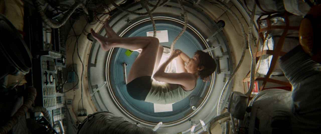 20 Movie Themes for Screenwriters to Explore 19 Astronaut Ryan Stone floats curled up in zero gravity inside a round spacecraft hatch.