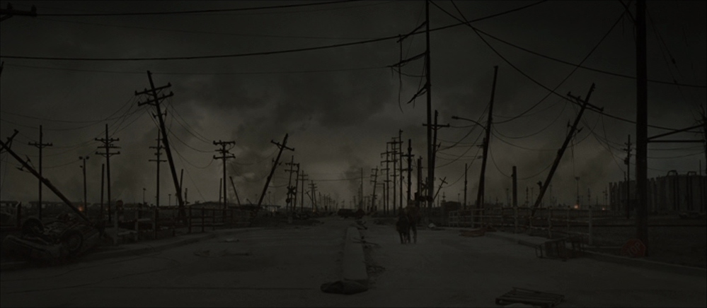 What Is Atmosphere in Writing? Definition & Examples 2 A desolate road covered in ash under dark clouds, with tilted power lines and two figures walking through the ruins.