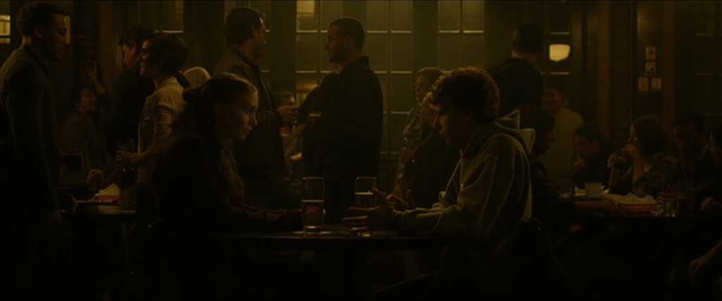 What Is a Take in Film? Definition, Purpose +Famous Examples 3 Mark and Erica sit at a bar table with drinks, mid-breakup, surrounded by students in dim lighting