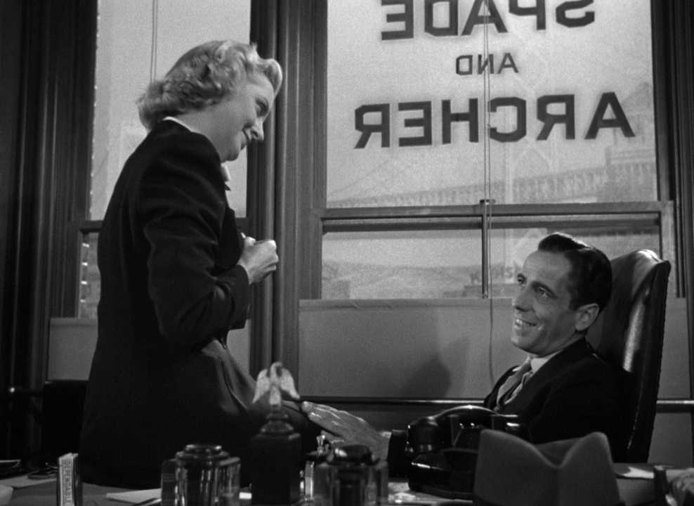 What Is the Studio System in Hollywood? How It Worked and Ended 3 Humphrey Bogart and Lee Patrick on a Warner Bros. soundstage in a crime noir office scene from The Maltese Falcon (1941)