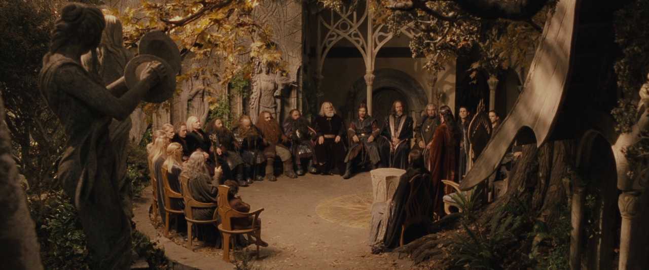 What Is World Building in Movies? Definition, Meaning & Examples 3 Elves, dwarves, and men sit in a stone circle beneath trees and carved statues during the Council of Elrond in Rivendell.