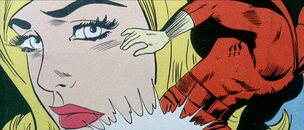 What is a Triadic Color Scheme? Definition & Movie Examples 6 A stylized comic panel of a woman’s face with yellow hair and a red-gloved hand. Blue background creates a bold triadic color scheme.