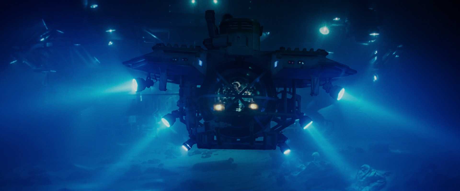Settings Ideas and Examples for Film Scenes 18 Submersible vehicle lit by blue spotlights moves slowly through deep underwater darkness