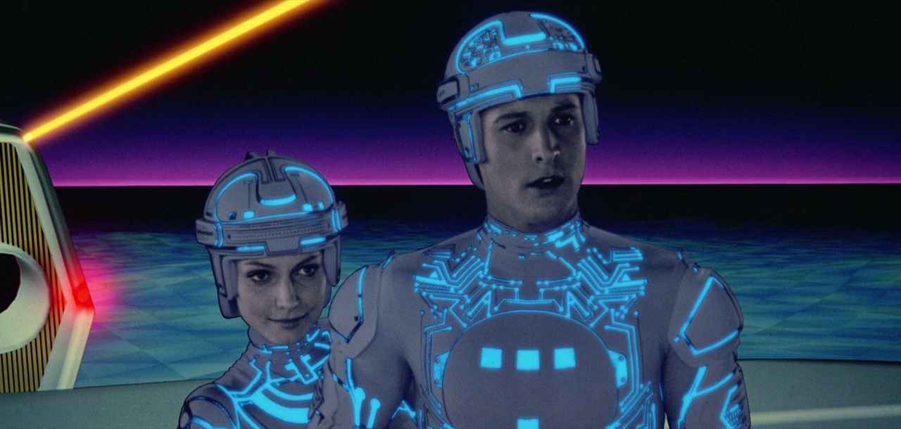Settings Ideas and Examples for Film Scenes 20 Two characters in glowing blue suits stand in a stylized digital world with grid floors and neon backgrounds