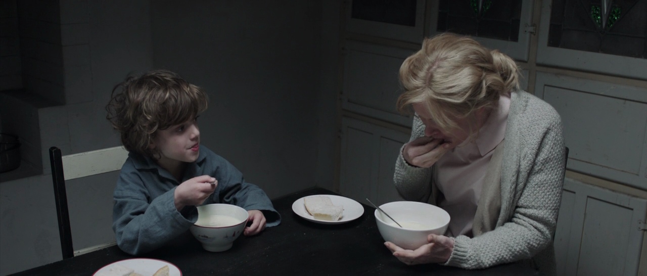 Settings Ideas and Examples for Film Scenes 6 A mother and son eat breakfast in a cold, dimly lit kitchen with white bowls and pale light