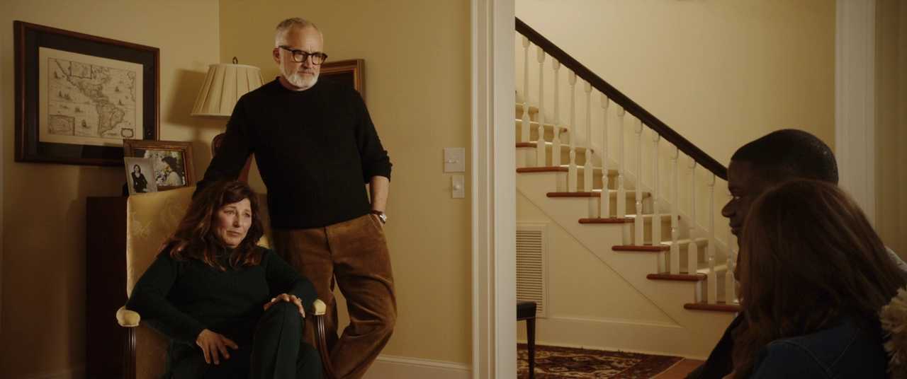 What Is Figurative Language? Definition and Examples 2 Two white parents sit and stand in a warmly lit living room, calmly facing a Black man and woman seated with their backs to the camera