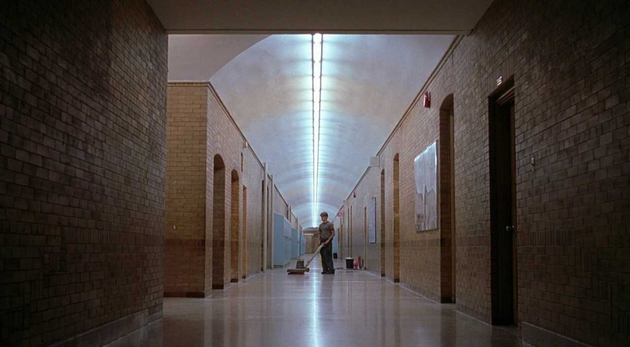 Settings Ideas and Examples for Film Scenes 12 A young janitor sweeps the floor in a long, symmetrical school hallway lit with fluorescent lights