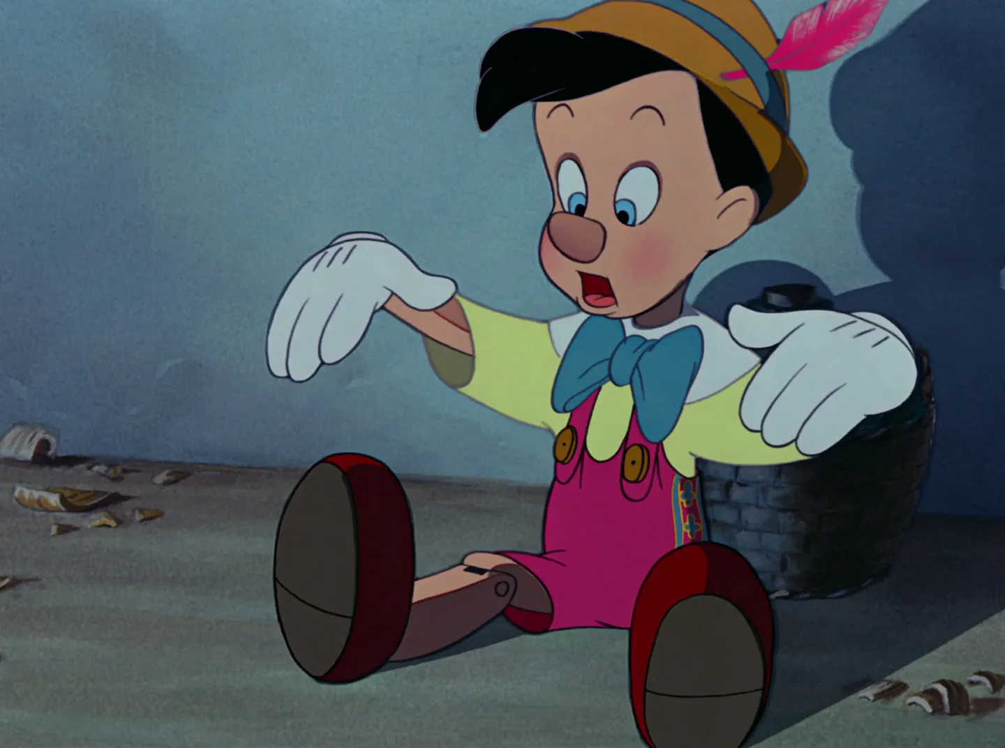 What is a Triadic Color Scheme? Definition & Movie Examples 4 Pinocchio sits on the floor in red overalls, a yellow shirt, and a blue bowtie — a balanced triadic palette.