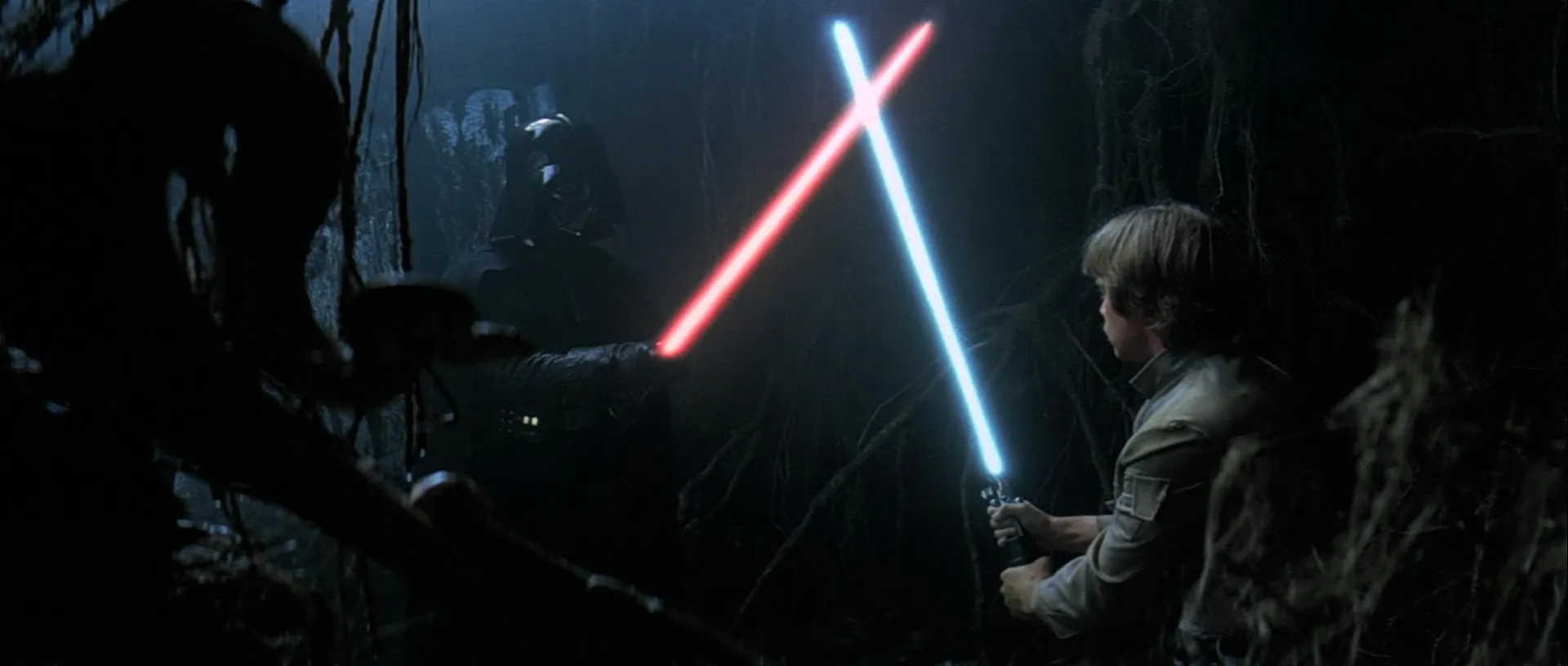 What is The Hero’s Journey? Story Structure Explained with Star Wars 10 Luke Skywalker clashes lightsabers with a vision of Darth Vader in a dark, foggy cave on Dagobah during Jedi training.