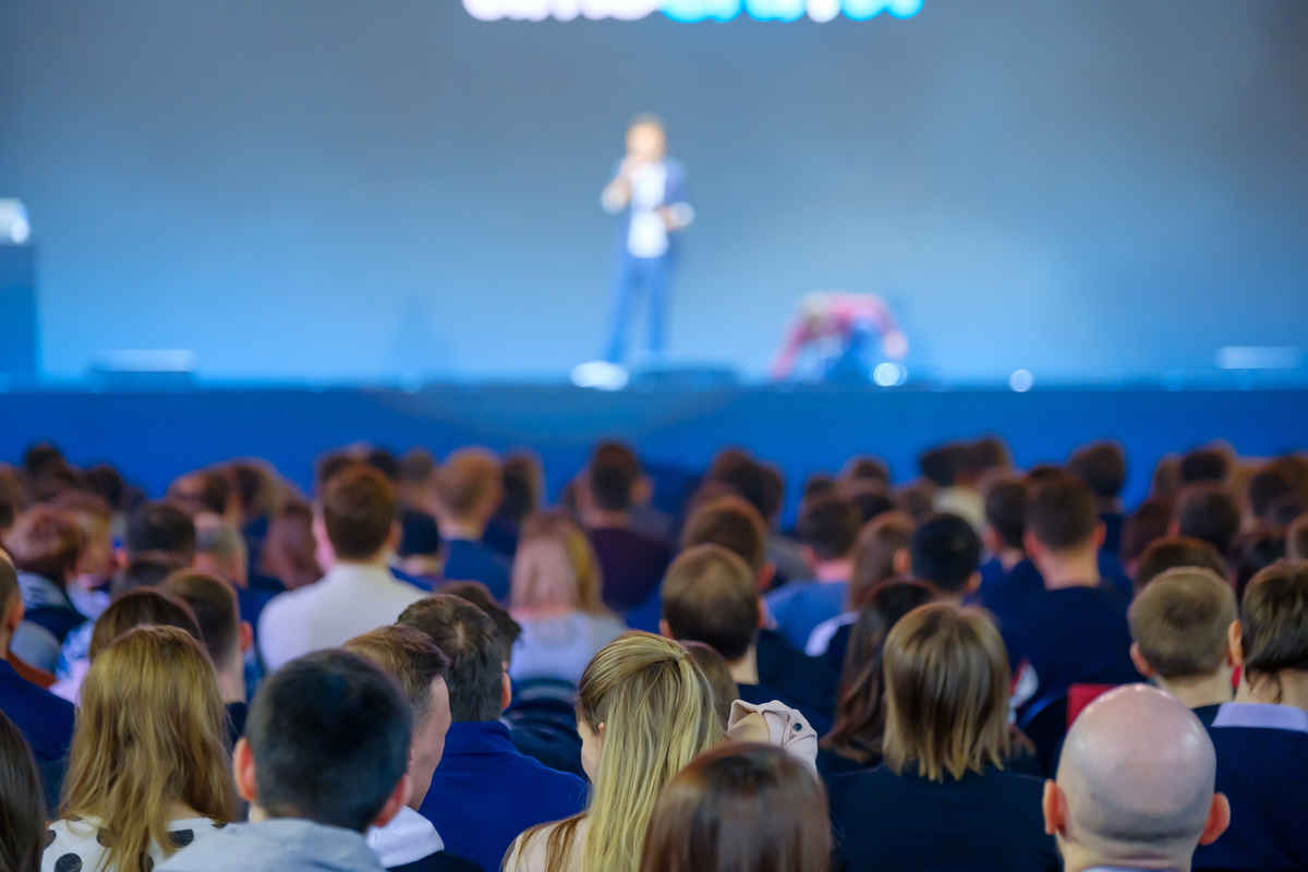 What Is a Model Release Form? Definition, Uses (+Free Template) 8 crowd at event with an unknown speaker