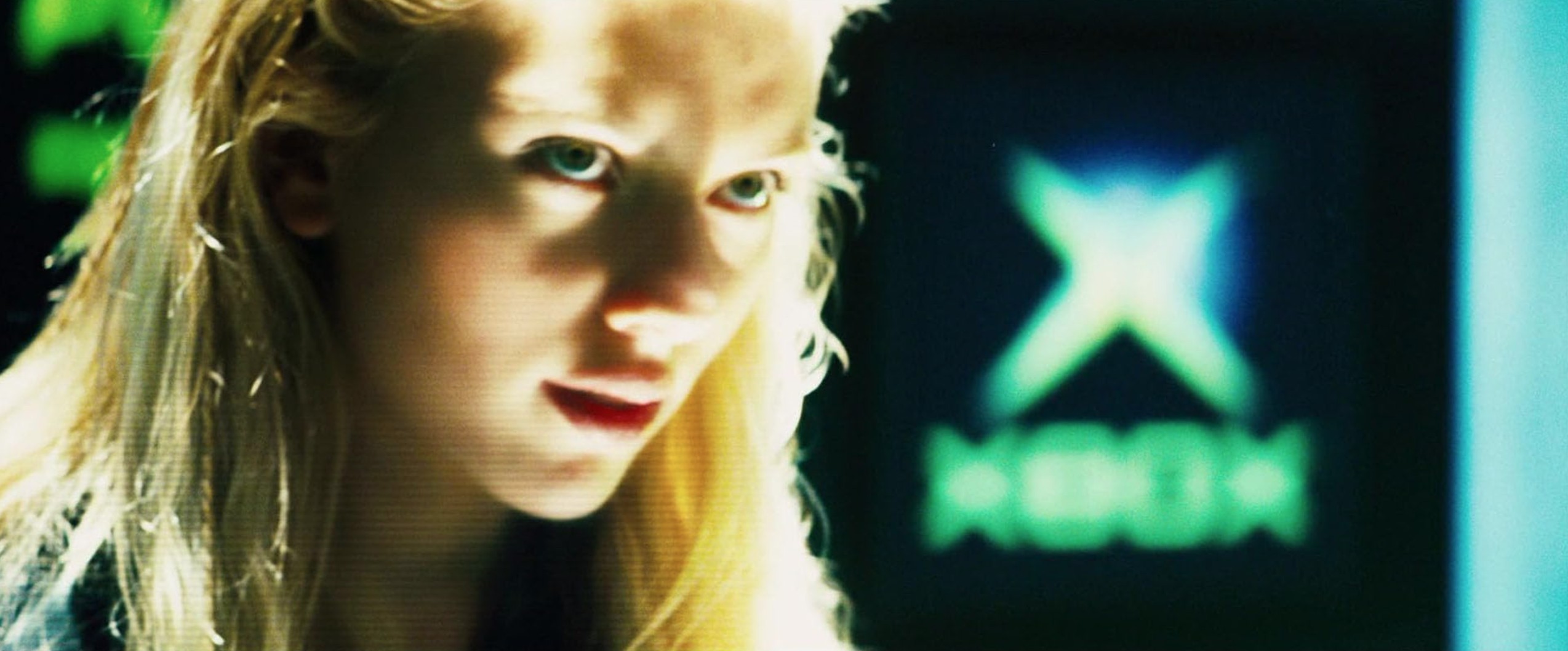 What Is Product Placement in Film? Meaning, Uses & Examples 6 Close-up of Scarlett Johansson with a glowing Xbox logo behind her in a sci-fi setting