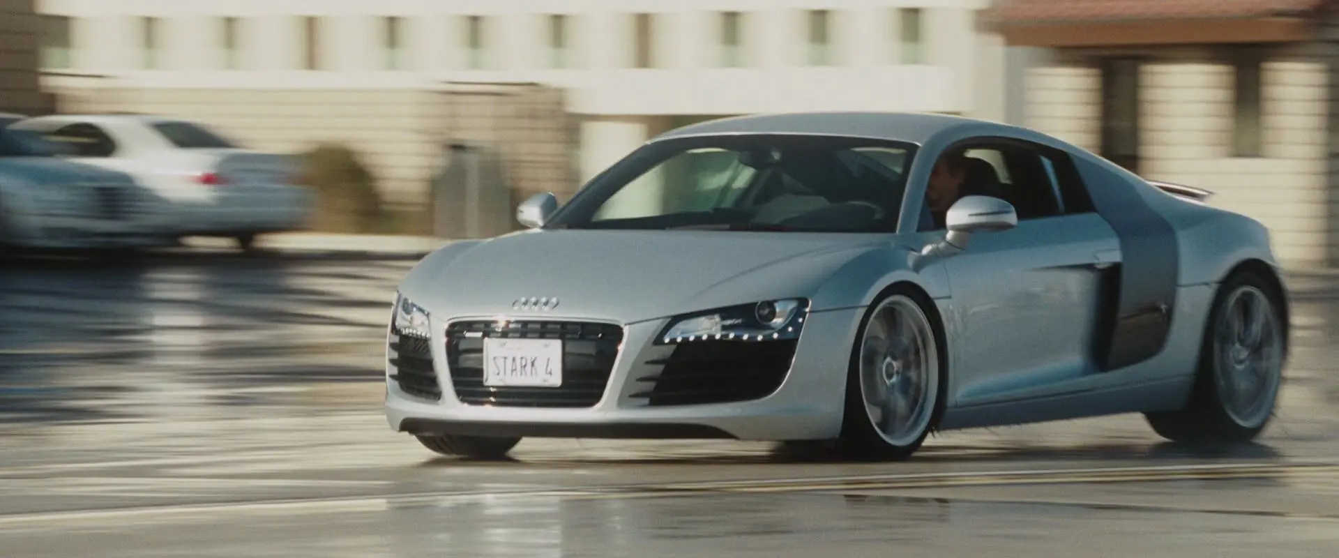 What Is Product Placement in Film? Meaning, Uses & Examples 4 Tony Stark speeds through a parking lot in a silver Audi R8, with the license plate reading “STARK 4”
