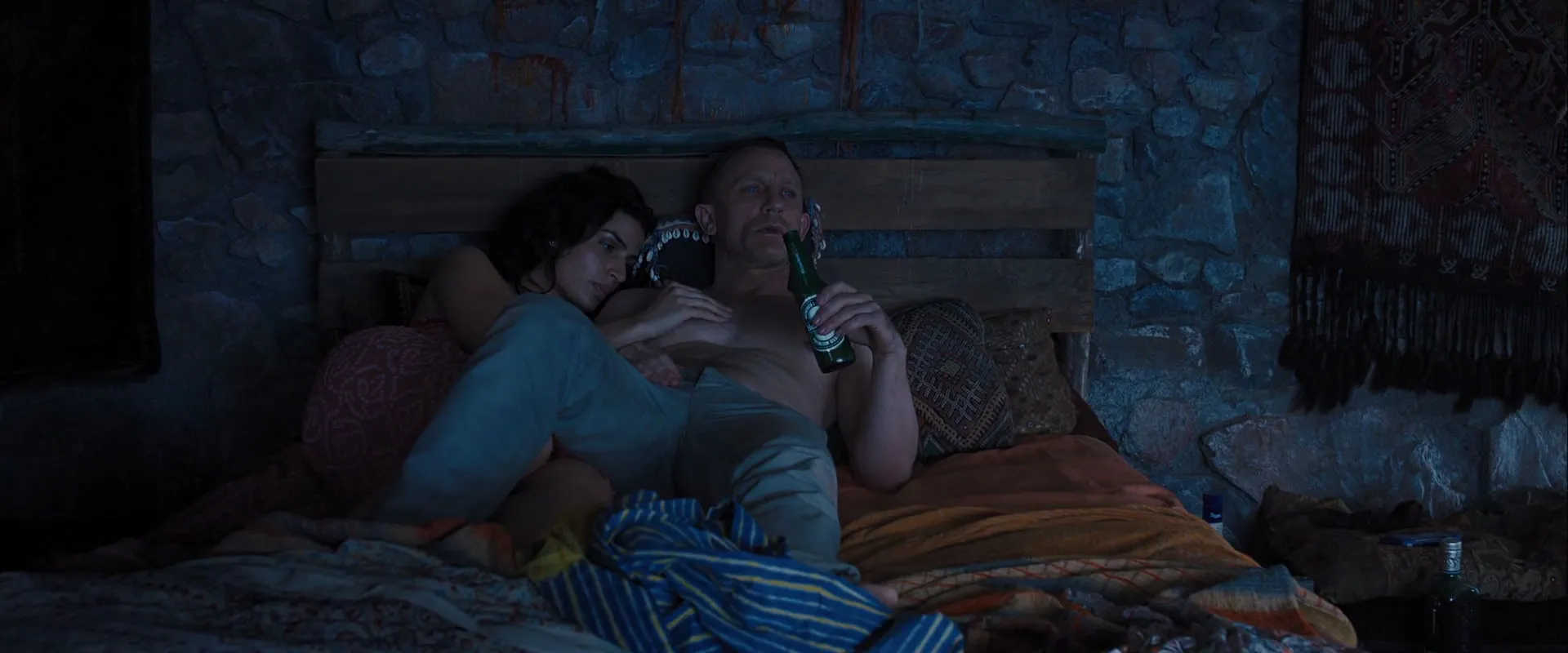 What Is Product Placement in Film? Meaning, Uses & Examples 7 James Bond (Daniel Craig) reclining shirtless on a bed with a woman beside him, holding a Heineken beer bottle