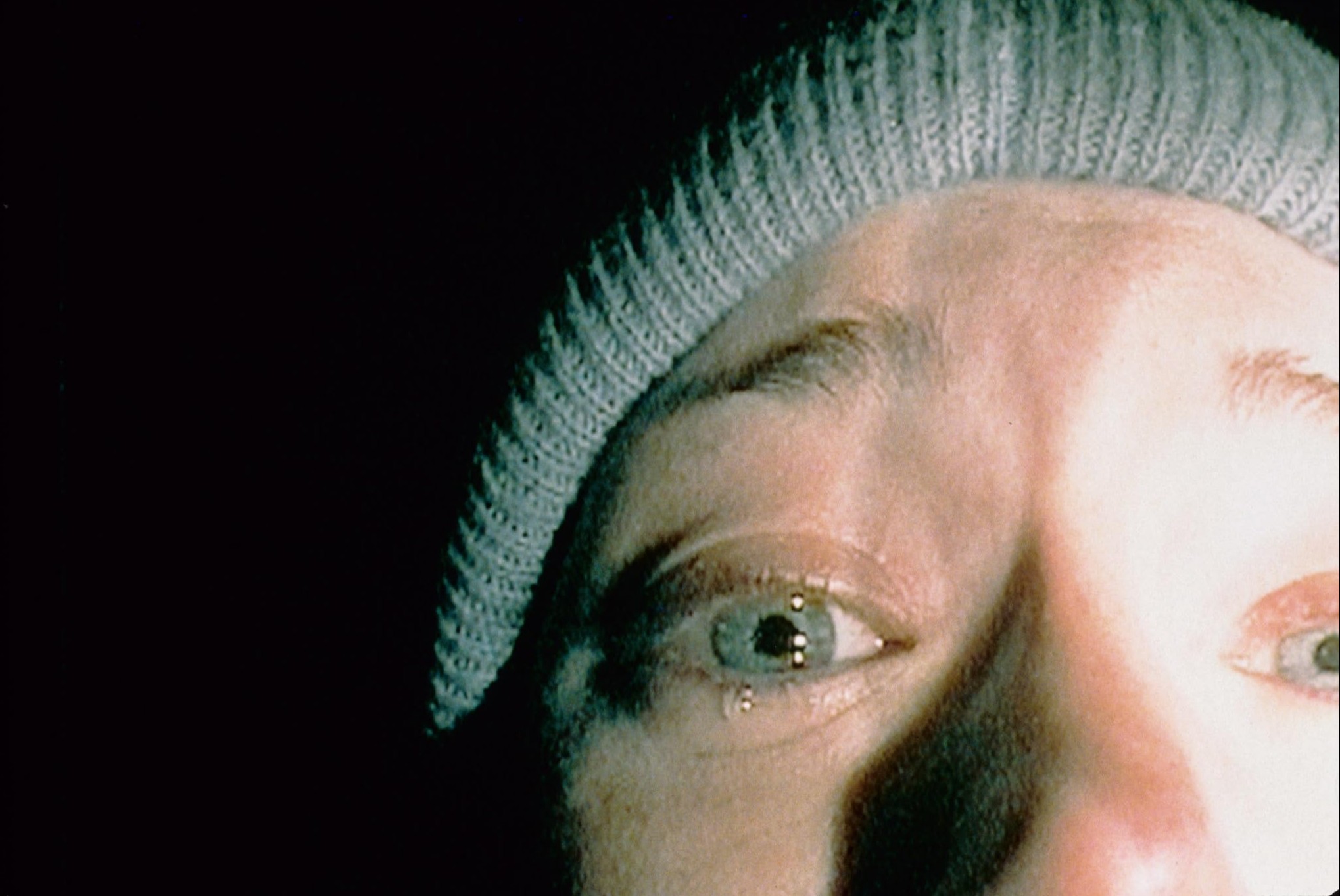 What is a Legend? Definition, Meaning, and Film Examples 6 Close-up of Heather’s face in low light with a tear on her cheek, wearing a knit cap.