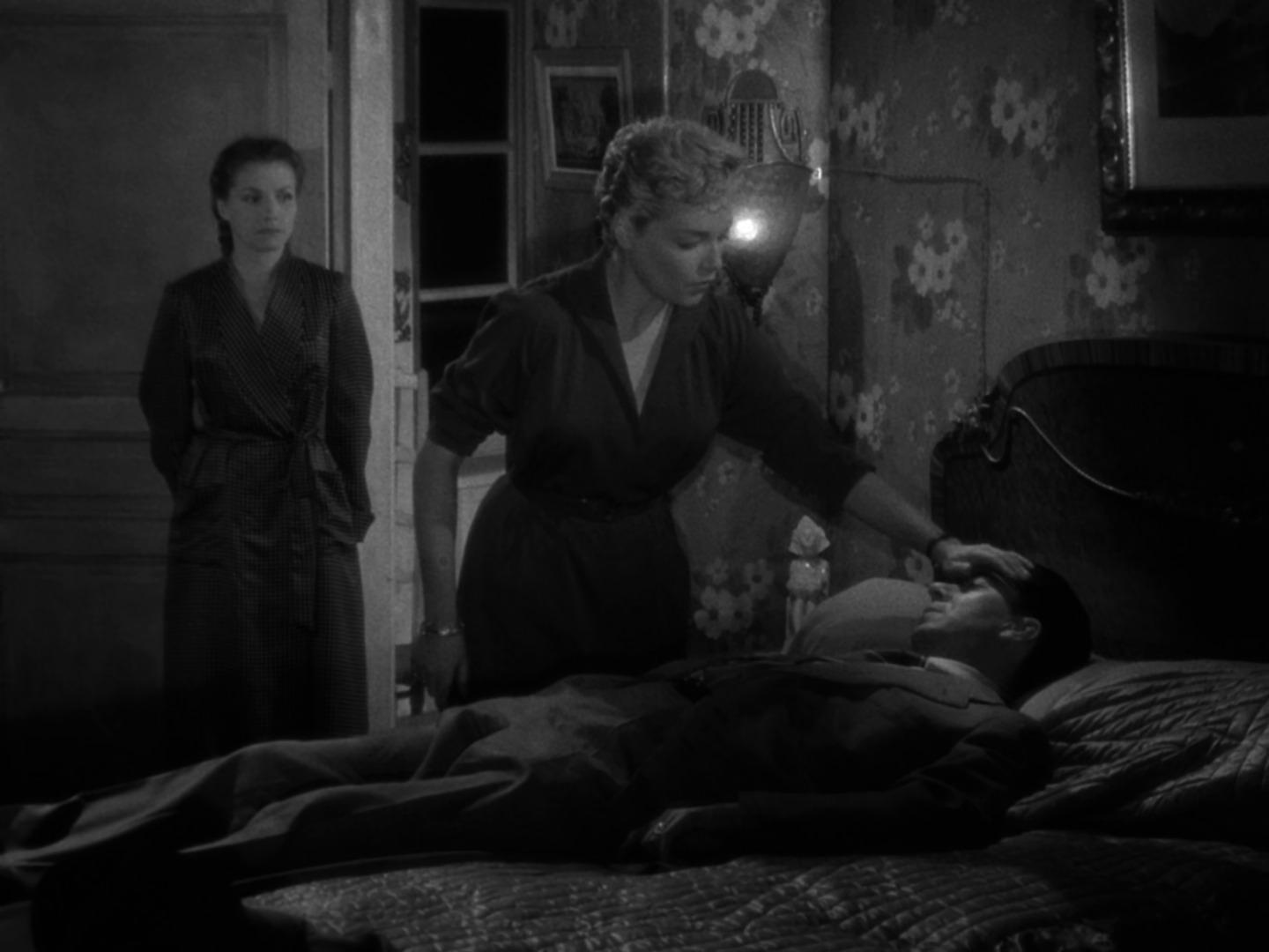 Best Mystery Movies of All Time: 25 Picks Explained 17 Black-and-white bedroom scene where a woman leans over a man lying on a bed while another woman stands in the doorway watching.