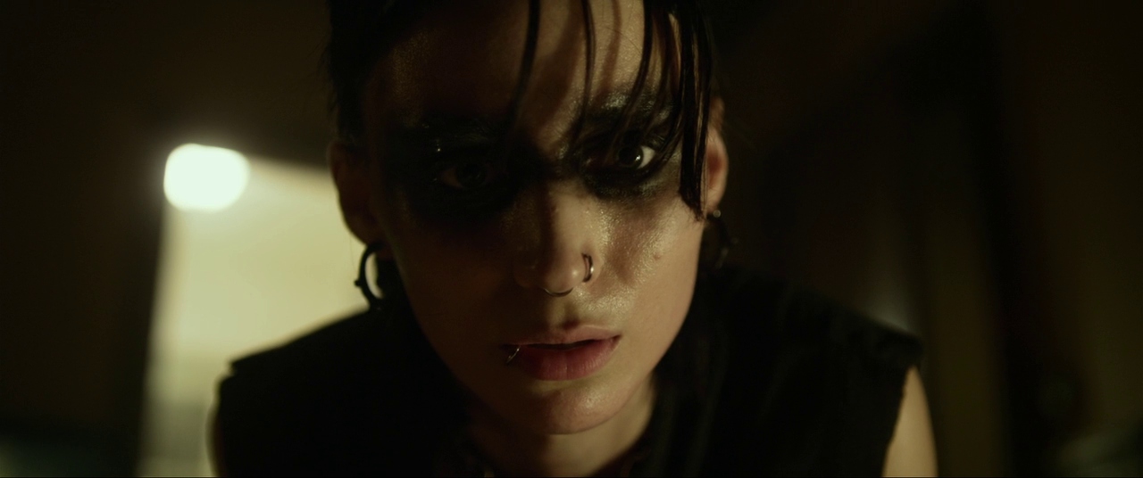 Best Mystery Movies of All Time: 25 Picks Explained 24 Close-up of a woman with dark eye makeup and wet hair partially covering her face, looking intensely toward the camera in a dimly lit room.