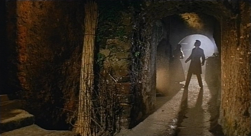 Mario Bava: The Man Who Invented Italian Horror 5 A man and woman stand in an ornate corridor, looking confused as the long hallway stretches around them in a gothic mansion.