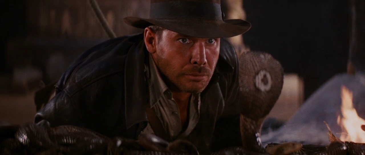 100+ Best Movie Quotes of All Time: The Definitive List 5 Harrison Ford as Indiana Jones staring at a cobra in the Well of Souls in Raiders of the Lost Ark (1981)