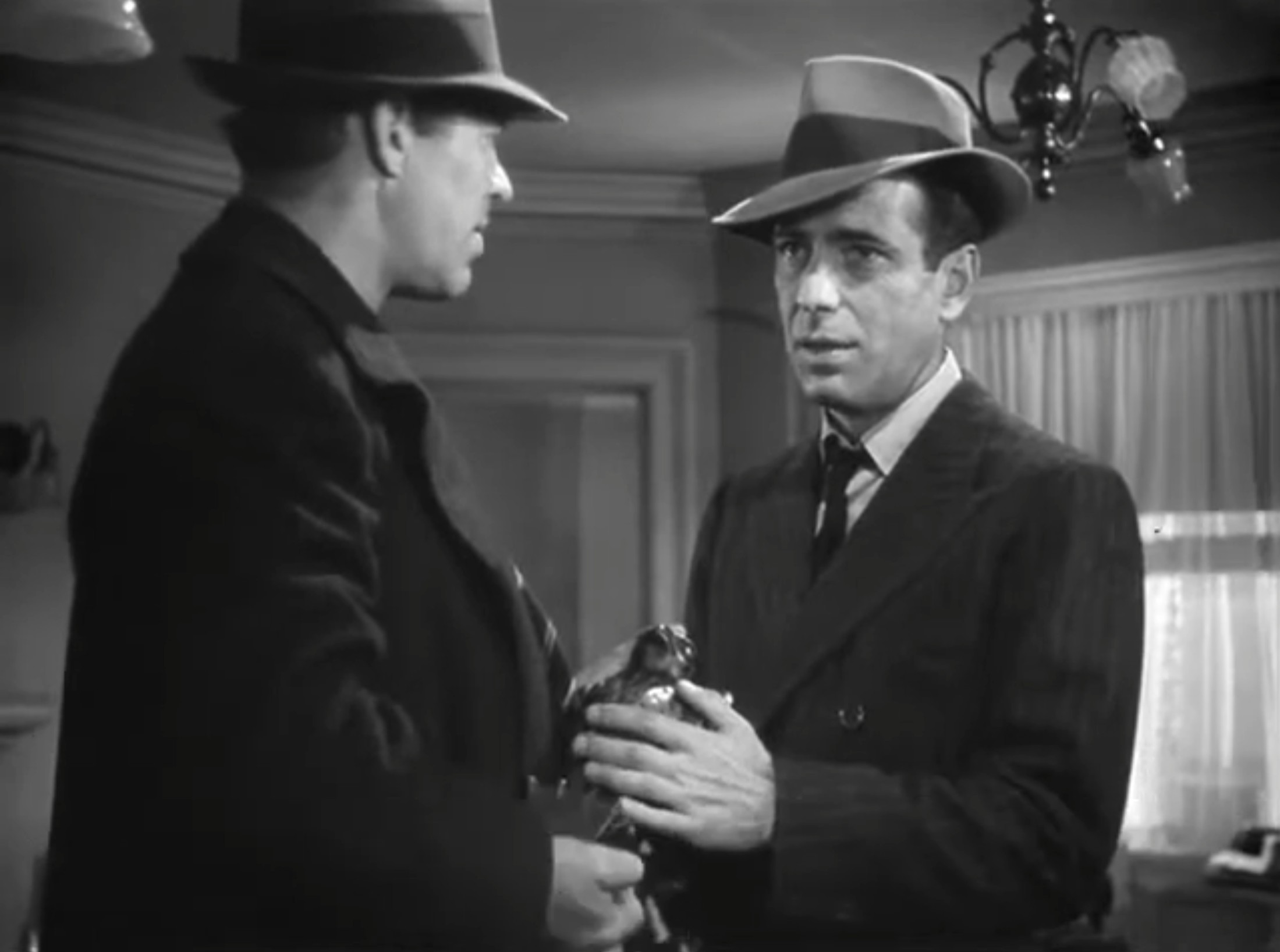 100+ Best Movie Quotes of All Time: The Definitive List 9 Humphrey Bogart as Sam Spade holding the Maltese Falcon statuette in The Maltese Falcon (1941)